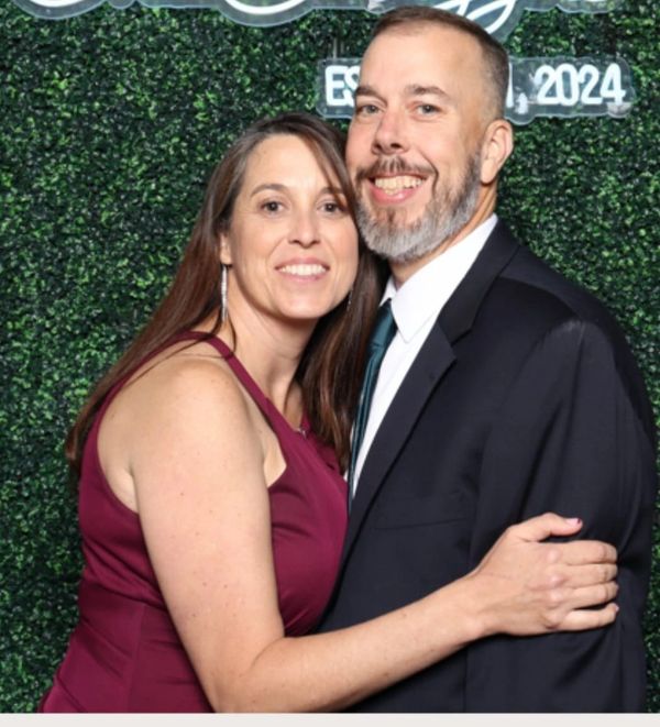Smiling couple embracing at an event.