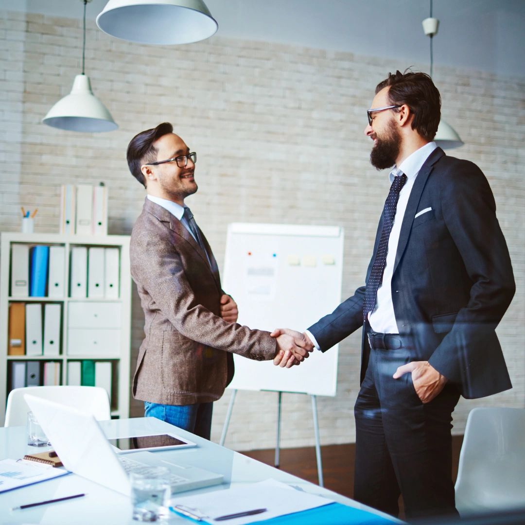 two business partners shaking hands with trust