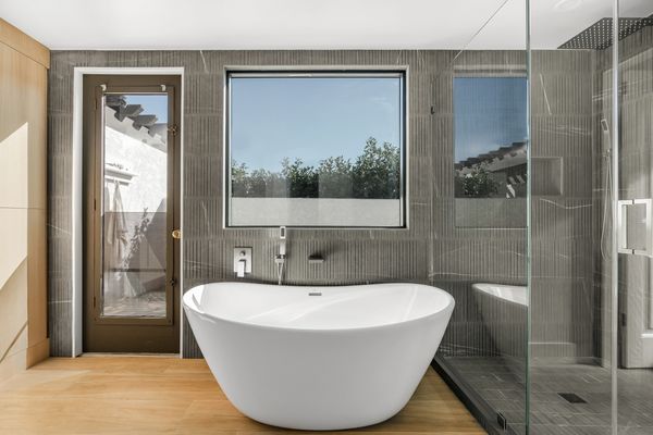 Full wall of Bedrosians tile wall in master bathroom. Fergusons bathtub. Custom master bath Temecula