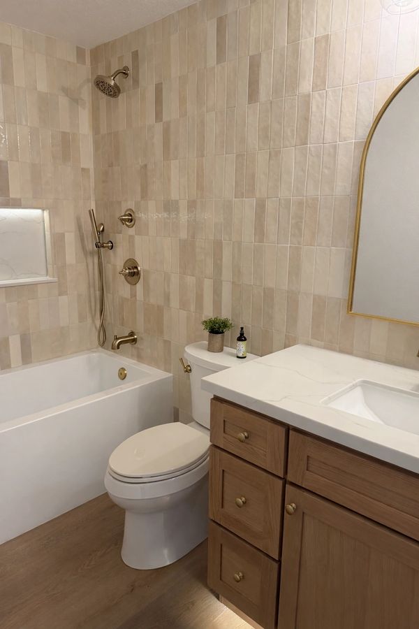 Fully tiled wall in bathroom with zeleige tile. Light up niche in shower. white oak vanity. Modern 