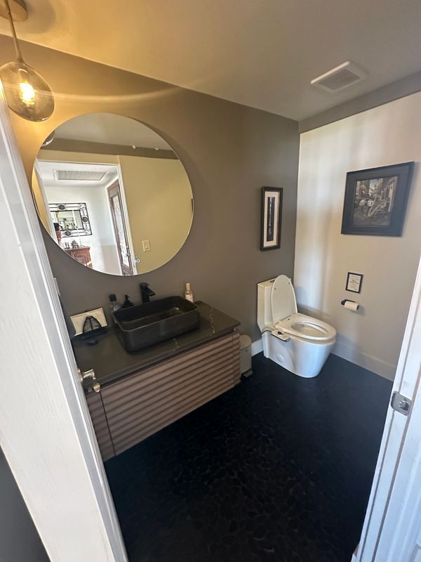 Guest bathroom upgrade by Justice renovations. Floating vanity with vessel sink. Bedrosians tile 