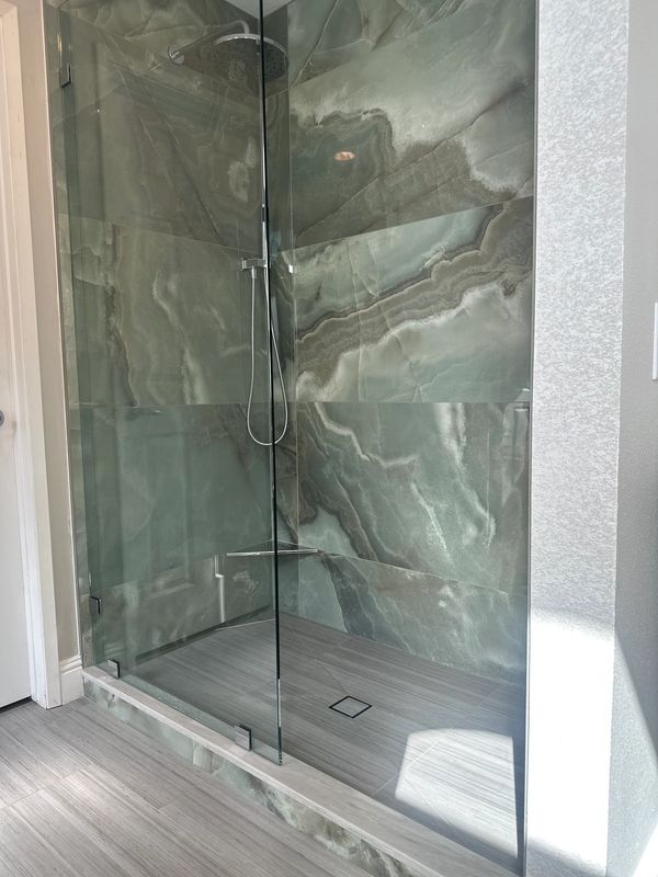 Green toned large format tile work by Justice Renovations. 