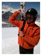 A man carrying a snow board wearing a helmet 