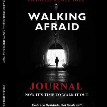 A person walks alone through a dark tunnel towards the light, symbolizing overcoming fear.