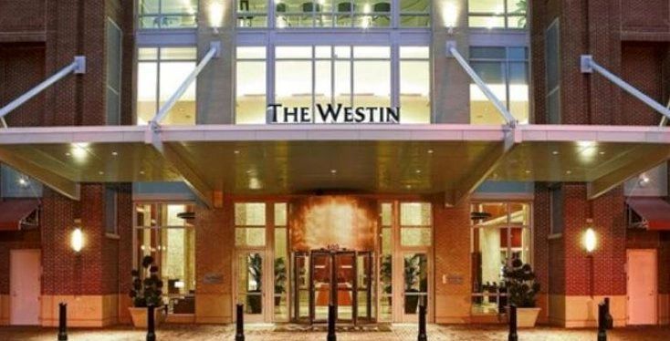 Entrance of The Westin hotel with modern glass and brick design.