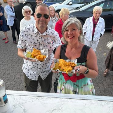 Couple holding Fish & Chips from The Hungry Plaice and THP Corporate Catering
