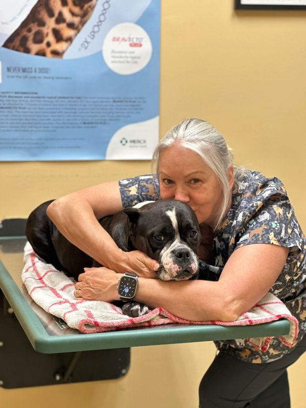 Pet Sitter Wendy with her dog Millianna at work at Grand Oaks Pet Hospital in Orlando, FL