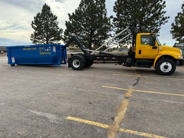 roll-off dumpster being picked up