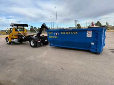 hook truck dropping a roll-off dumspter