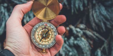 Man holding a gold compass