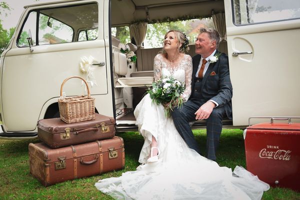 Bride and groom posing for wedding photography in Mansfield in a campervan. 