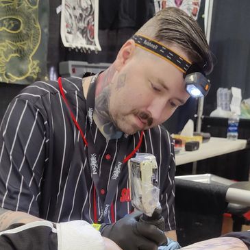 tattoo artist Chris Purdy tattooing at Inksane Asylum tattoo in Pensacola Florida