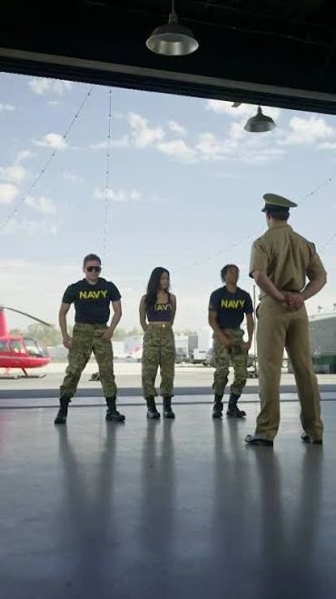 Navy personnel in training with an officer.