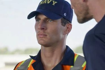 Navy officer in uniform with a serious expression.