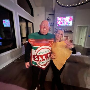 Couple dressed as salsa and tortilla chip costumes.