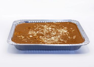 Almond-topped chocolate dessert in a rectangular foil tray.