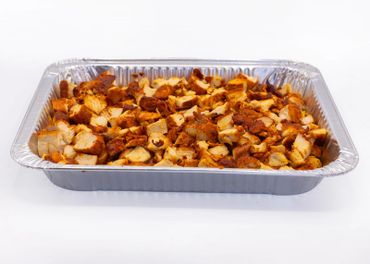 Tray of cooked, seasoned chicken pieces ready to serve.