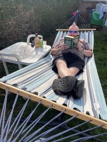 Cousin Peter enjoying some time in the hammock with his copy of Graham