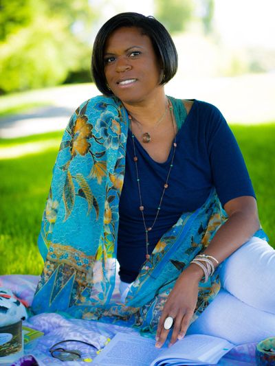 Black woman wearing blue scarf and jewelry