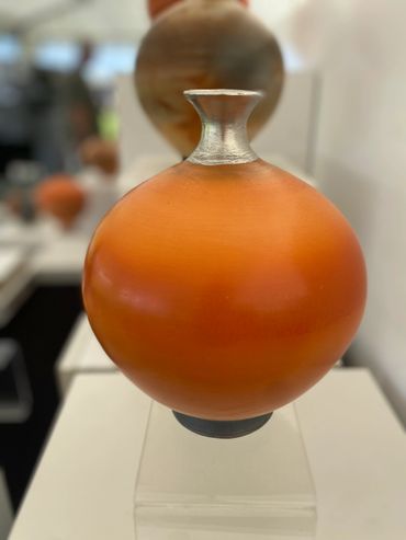 Vessel with wild clay terrasigilllata with silver neck
