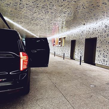 Black SUV parked at valet service.