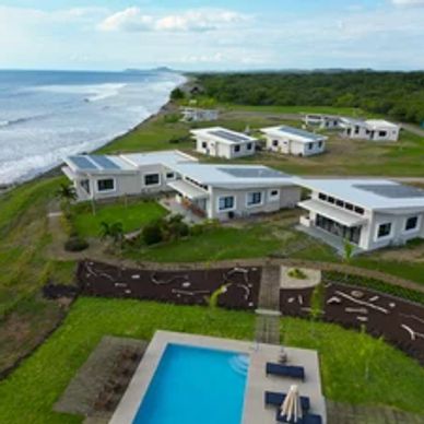 Modern beachfront homes with a pool and ocean views.