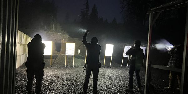 Group of students shooting while using flashlights and weapon mounted lights.