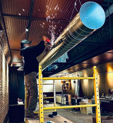 Gomez Mechanical Heating and Cooling Employee Installing Custom Vents and Ductwork Trenton, MI