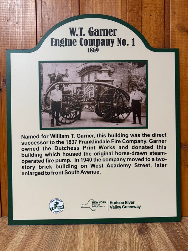 Historical sign for W.T. Garner Engine Company No. 1 with an old fire pump photo.