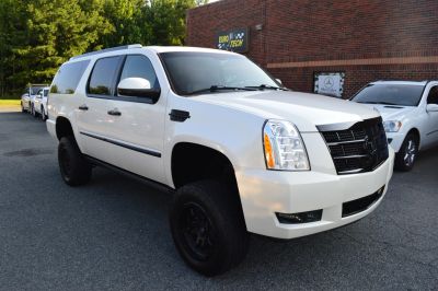 White Cadillac Escalade SUV parked outdoors.