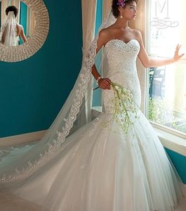 Bride in wedding gown gazing out of a window.