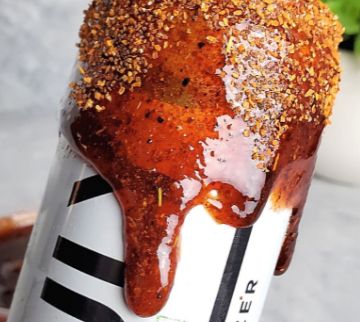Spicy Mami Chamoy Rim Dip dripping down the outside of a beverage can.