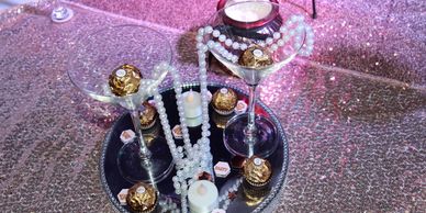 Picture of themed table décor with beads and chocolates in martini glasses