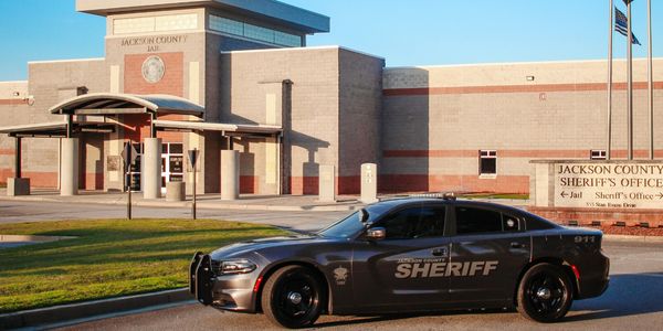 Jackson County Sheriff's Office and Jail with a sheriff's car parked outside.