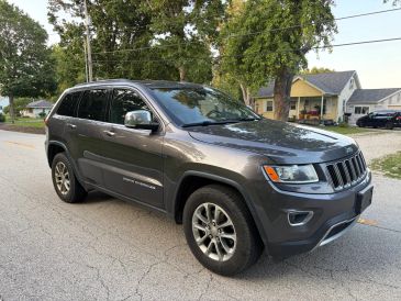 Gray Jeep Grand Cherokee parked on a street.