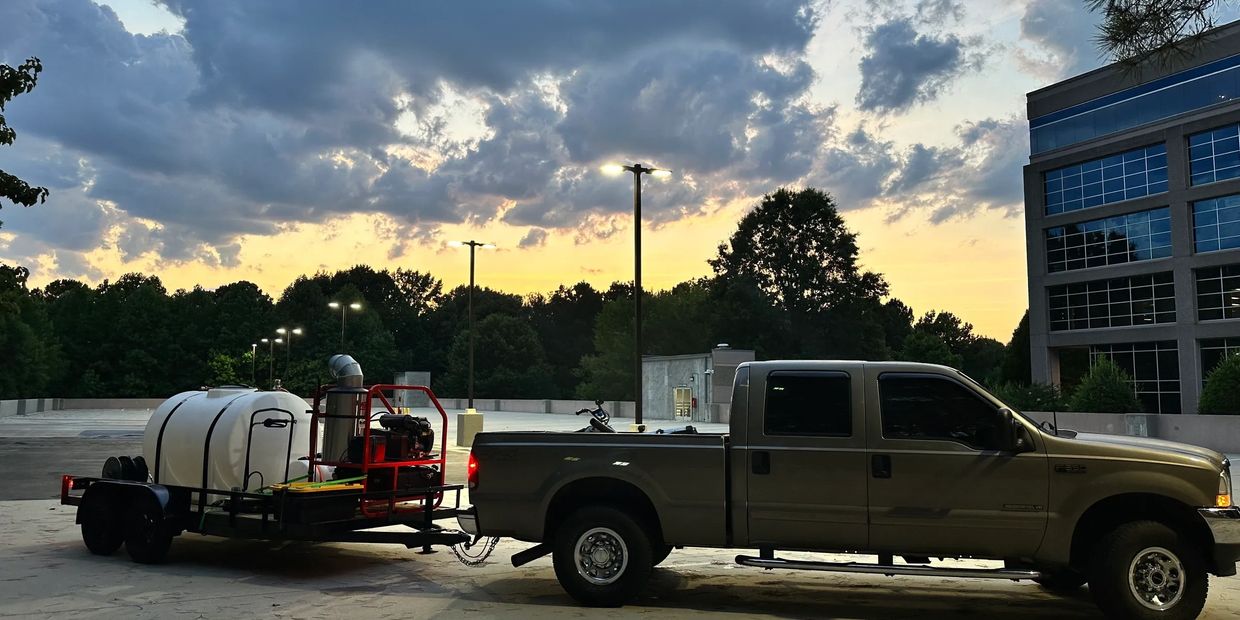 truck and pressure washing equipment at sunset on a parking deck Bennie was cleaning
