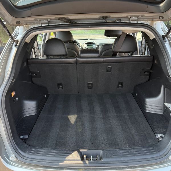 Empty car trunk with clean black interior.