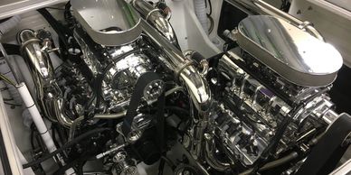 Dual polished chrome supercharged engines in a high-performance setup.