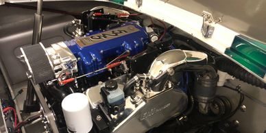 Close-up of a clean, detailed Triumph engine in an engine bay.