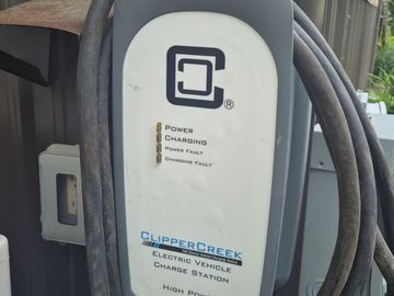 ClipperCreek electric vehicle charger with charging status indicators.