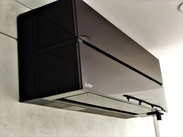 Sleek black Mitsubishi wall-mounted air conditioner unit.