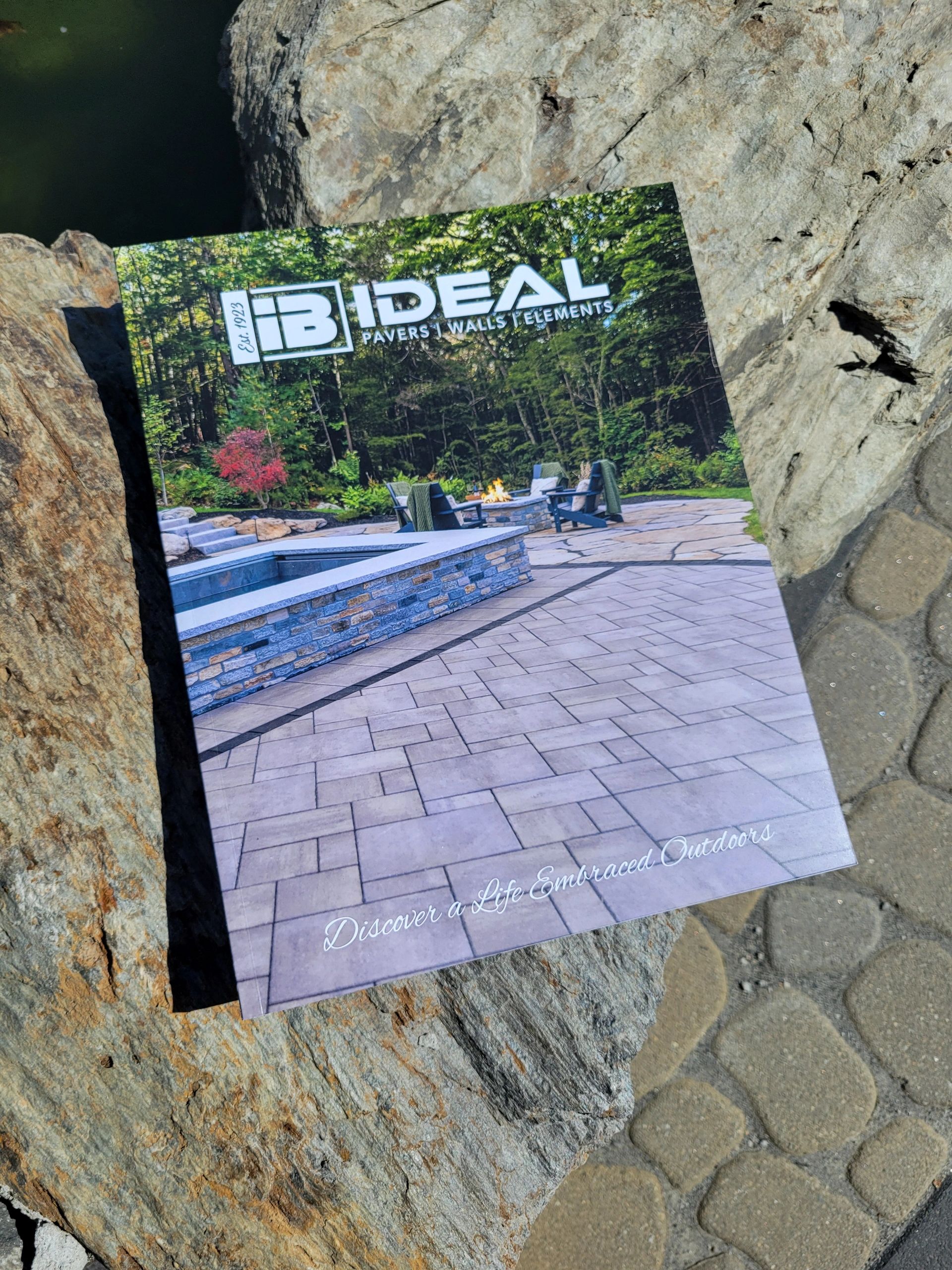 Catalog for Ideal Pavers, Walls, and Elements showcasing outdoor living spaces.