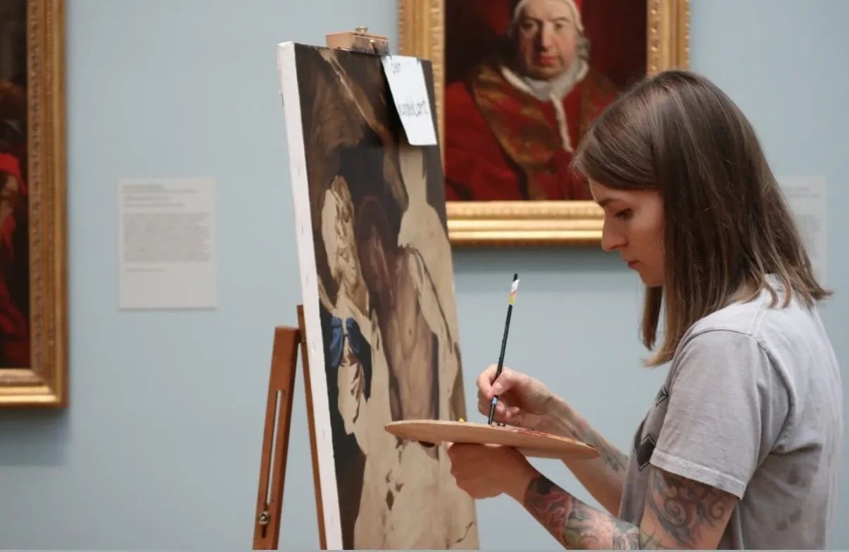 Korolek painting a master copy at the Met in New York, studying classical technique firsthand.
