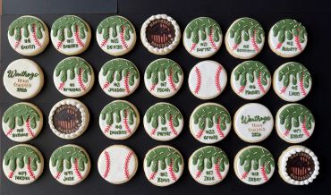 Array of decorated baseball-themed cookies with names and team details.