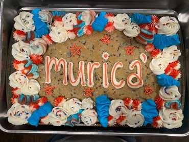 Large cookie cake with 'murica' and red, white, blue frosting.