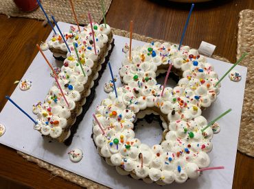 Number 18 cake with candles and sprinkles.