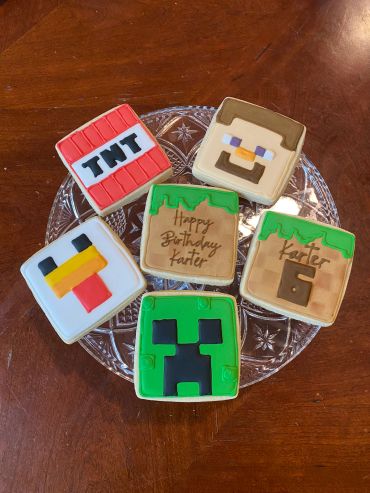 Minecraft-themed birthday cookies on a plate.