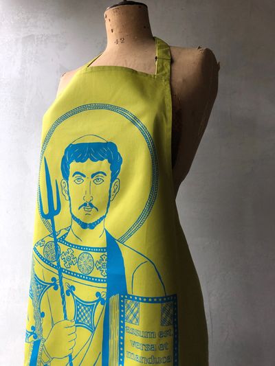 a yellow apron with a saint model.