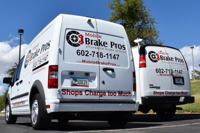 two mobile brake pros service vans in a park