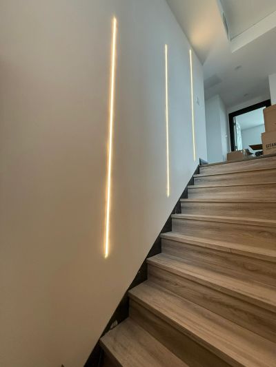 Modern staircase with vertical wall lighting.